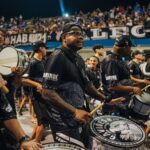 Exciting drum band performance during a vibrant carnival in São Paulo, Brazil, capturing cultural celebration.