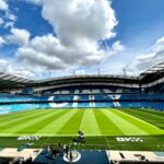 A view of the iconic Etihad Stadium in Manchester, United Kingdom, showcasing its vibrant football field.