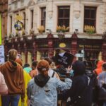 A group of protesters in Manchester advocating for transgender rights with vibrant signs and diverse participants.