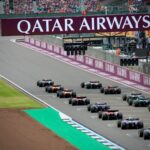 High-speed Formula 1 cars line up on the Silverstone Circuit, ready for an adrenaline-pumping race.