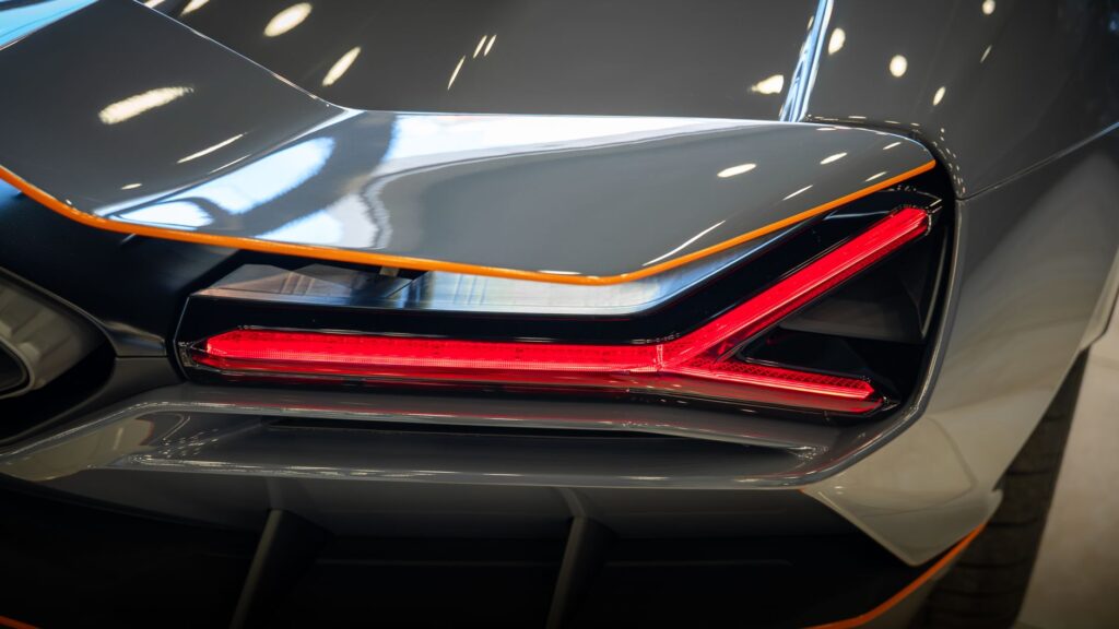 Detailed shot of a luxury car's rear tail light with sleek design and modern look.