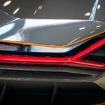 Detailed shot of a luxury car's rear tail light with sleek design and modern look.