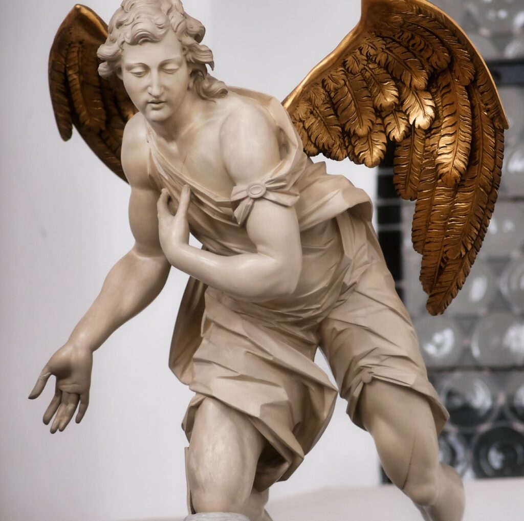 Close-up of a detailed angel sculpture showcasing intricate craftsmanship with golden wings.