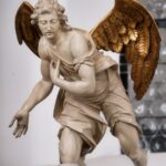Close-up of a detailed angel sculpture showcasing intricate craftsmanship with golden wings.