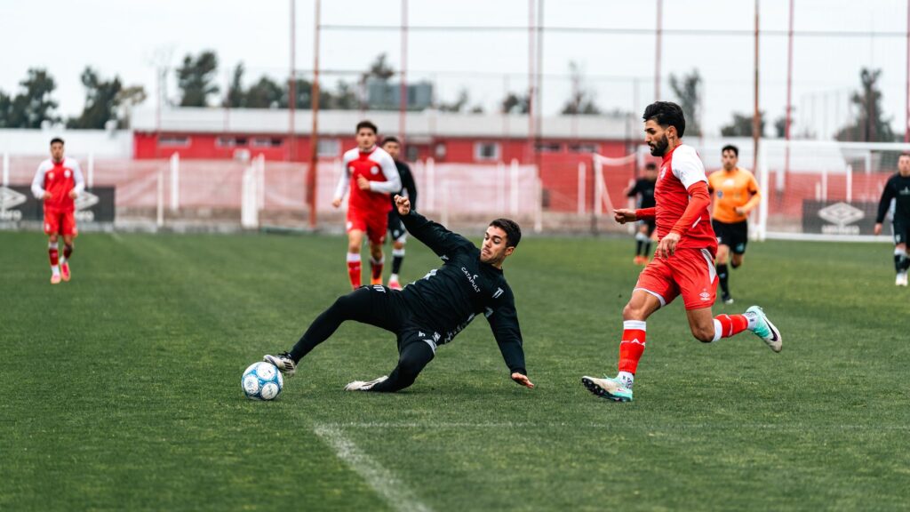Soccer players in action on an outdoor field, showcasing energy and teamwork.