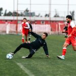 Soccer players in action on an outdoor field, showcasing energy and teamwork.