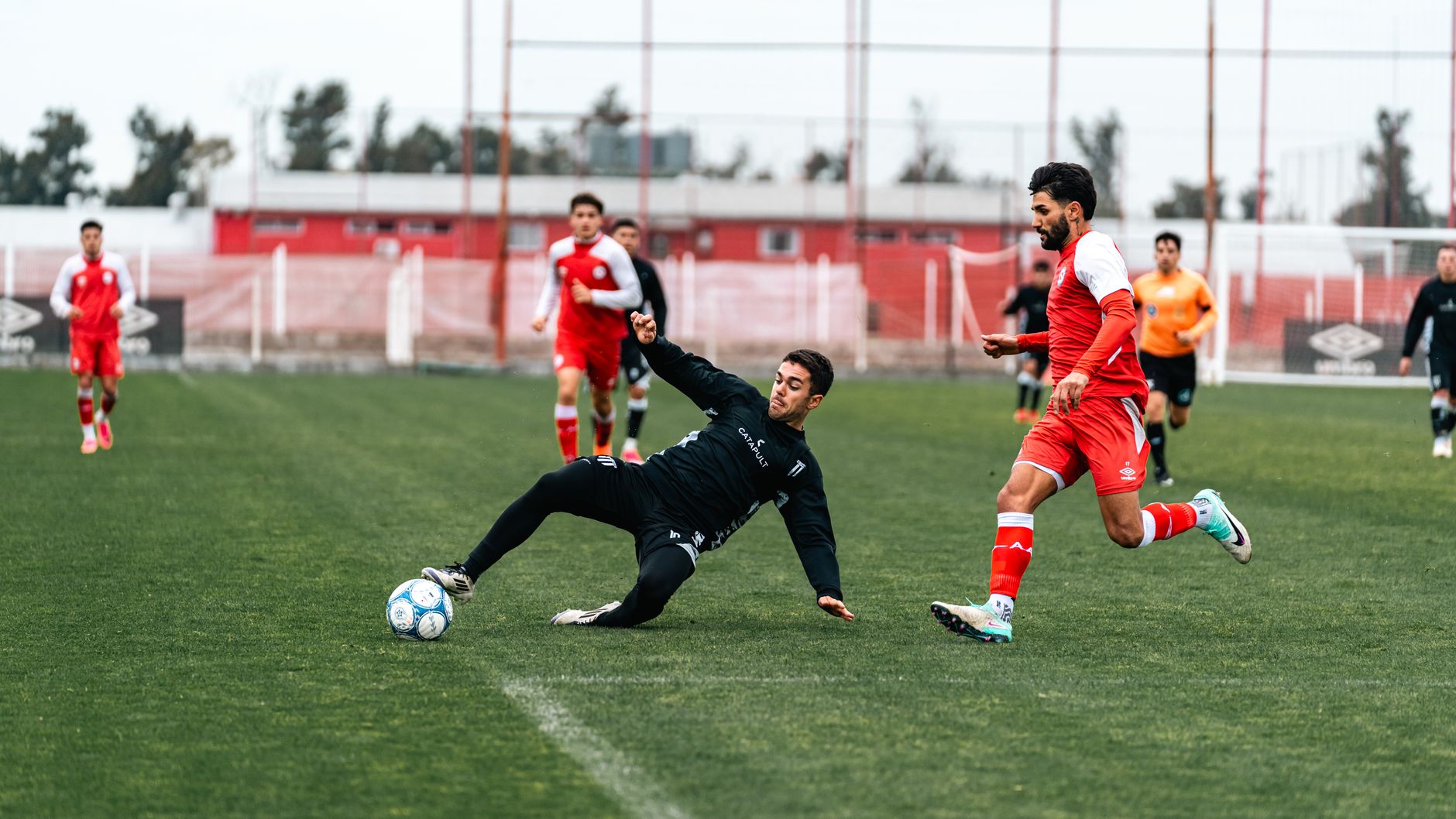 Soccer players in action on an outdoor field, showcasing energy and teamwork.