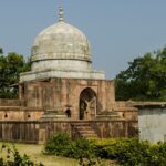 Hoshang Shah's Tomb, a historic mausoleum in Mandu, India, surrounded by lush greenery.