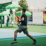 A male athlete playing tennis on a sunny day in Islamabad, Pakistan.