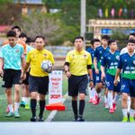 Football teams with referees walking onto the field in Hà Nội, Vietnam.