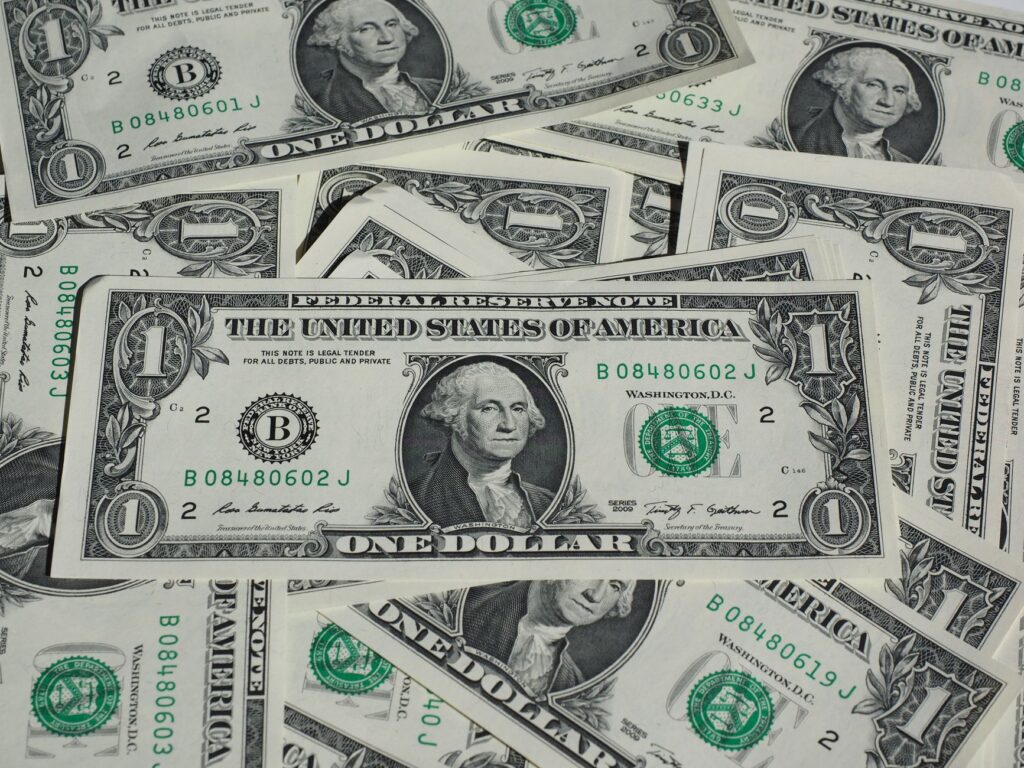 A detailed shot of a pile of U.S. one-dollar bills showcasing currency and finance concepts.