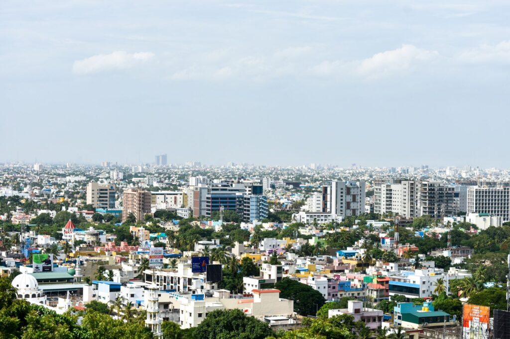 Aerial view of colorful high-rise buildings in Chennai, India, under a clear sky.