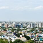 Aerial view of colorful high-rise buildings in Chennai, India, under a clear sky.