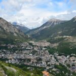 Stunning aerial shot of Puy-Saint-Pierre nestled in the French Alps, showcasing the town and mountains.