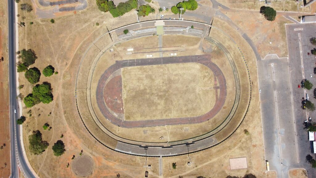 An aerial view of an empty stadium in Brasília, revealing its oval track and field.