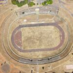 An aerial view of an empty stadium in Brasília, revealing its oval track and field.