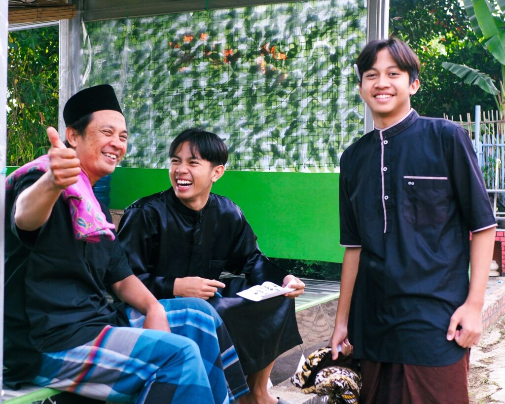 Three friends laughing and enjoying time together outdoors.