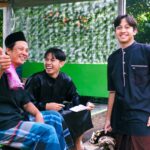 Three friends laughing and enjoying time together outdoors.