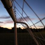 A serene sunset view highlighting a soccer goal net in a Louisville park, perfect for sports enthusiasts.