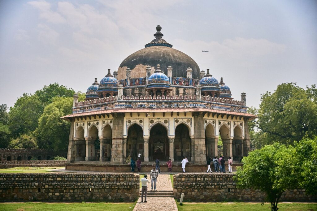 The majestic Isa Khan's Tomb stands amidst lush greenery in Delhi, showcasing Mughal architecture.