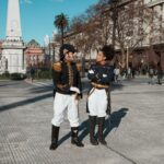 Historical reenactors in uniform at Plaza de Mayo, Buenos Aires, Argentina, with Casa Rosada view.