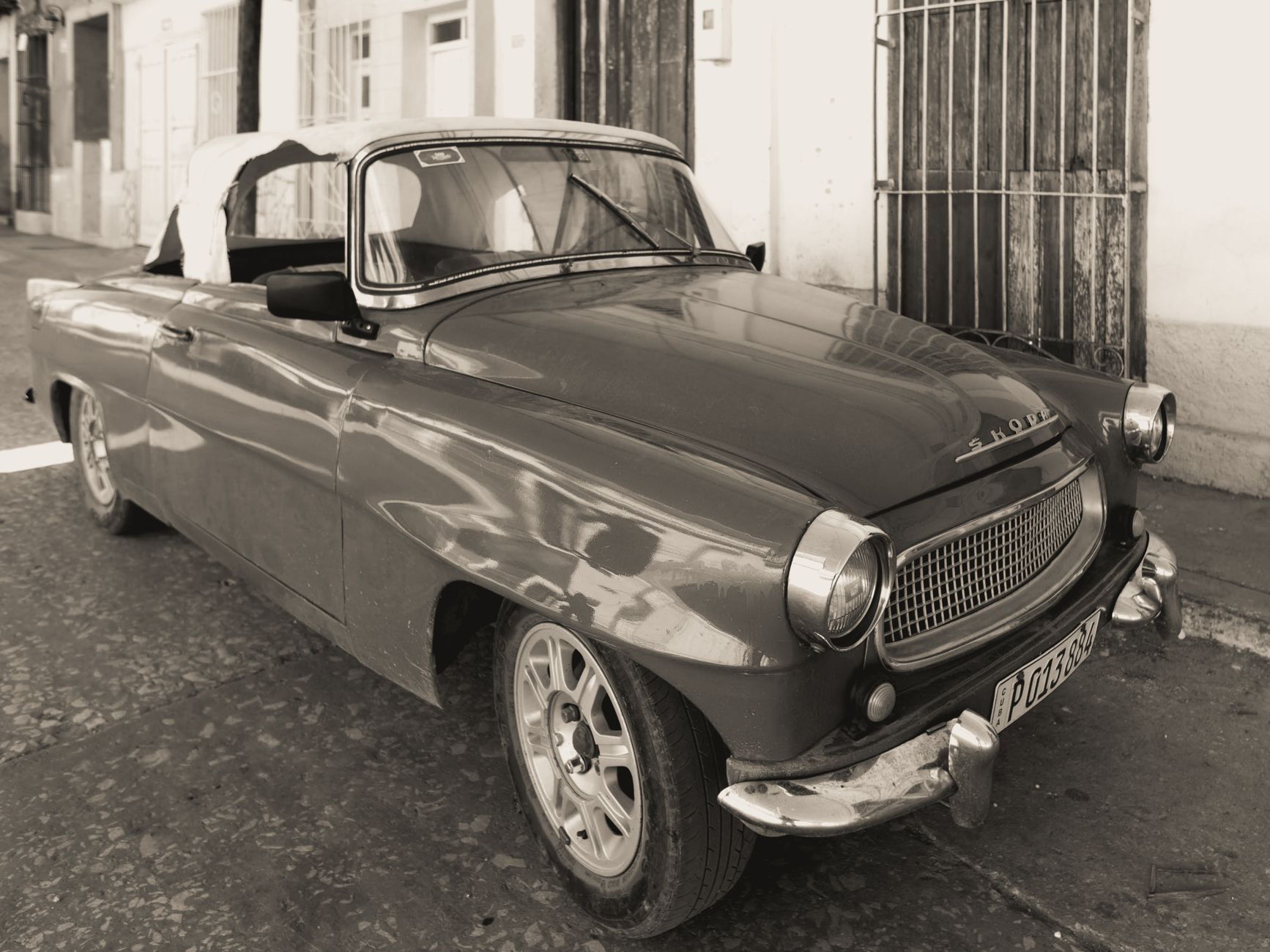Classic Skoda Felicia parked on an urban street, captured in timeless black and white.