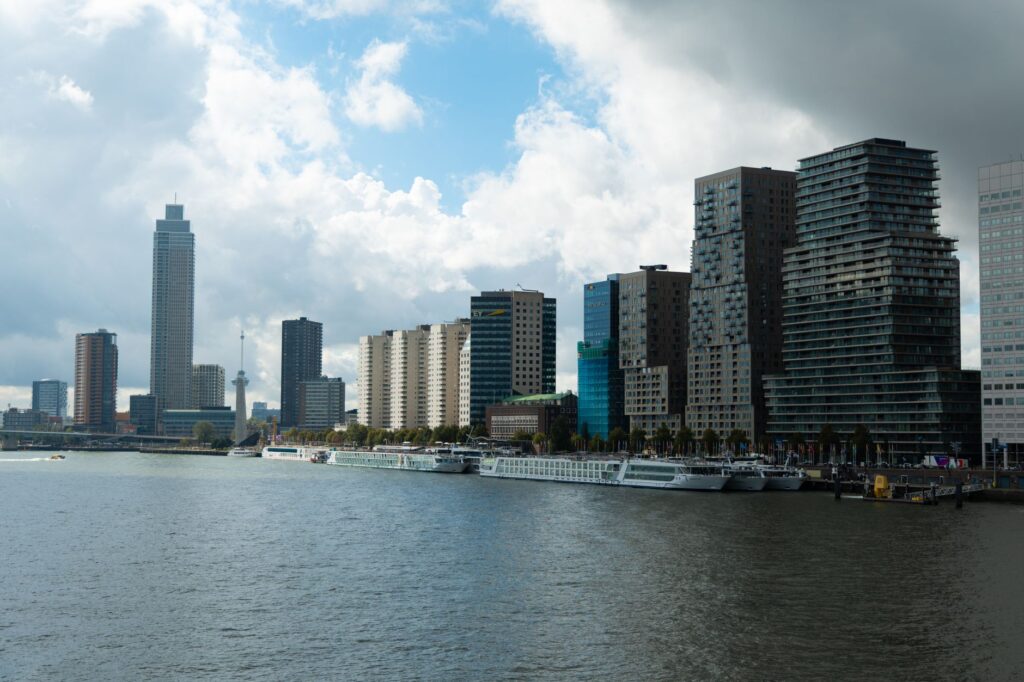 Explore Rotterdam's contemporary skyline with skyscrapers along the Nieuwe Maas.