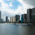 Explore Rotterdam's contemporary skyline with skyscrapers along the Nieuwe Maas.