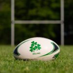 Rugby ball on grass in Galway, Ireland. Perfect for sports themes.