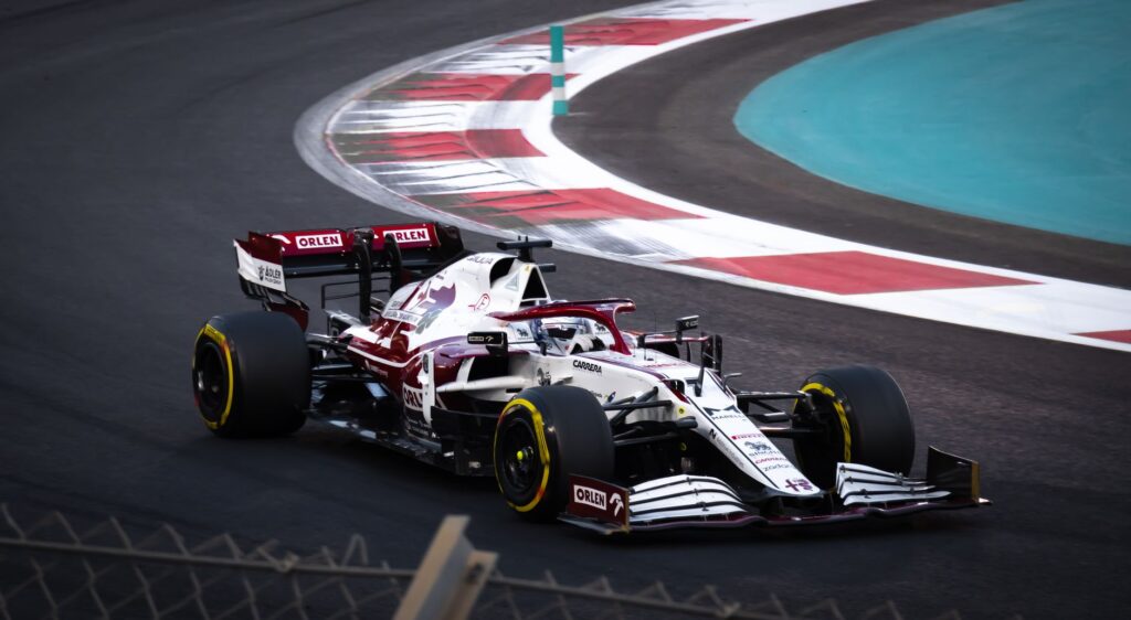 Dynamic shot of a Formula 1 car racing on a modern track during the day.