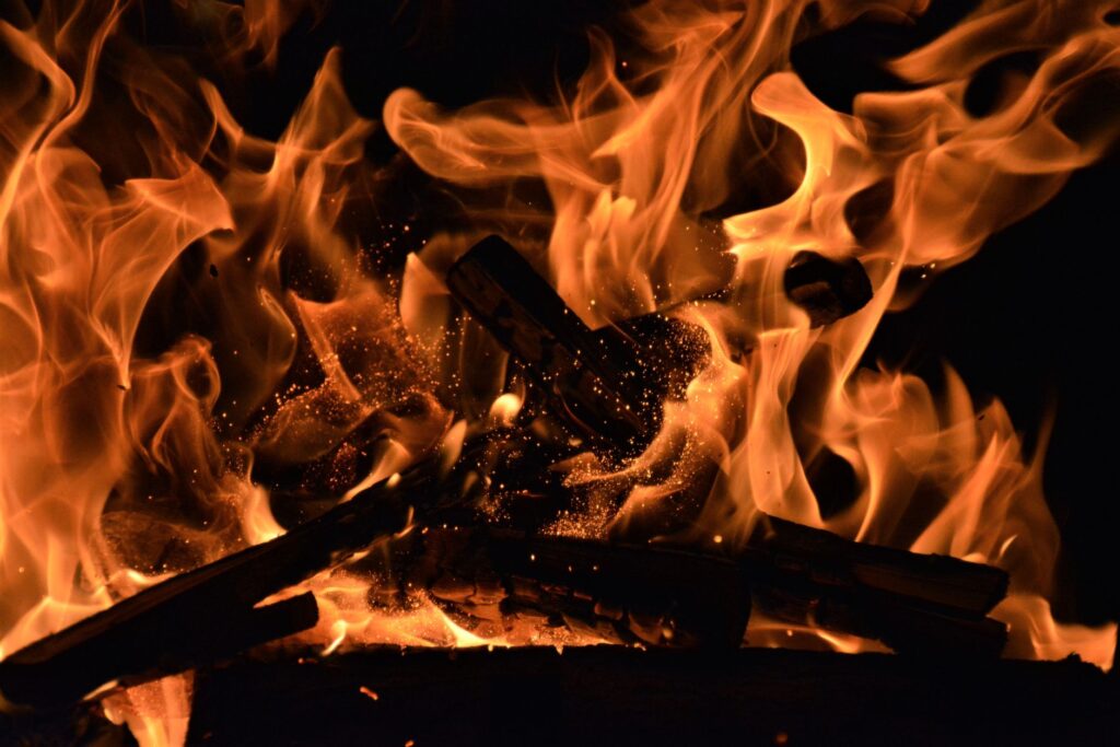 Close-up of roaring flames with glowing embers radiating heat and light. Perfect for warm and vivid backgrounds.