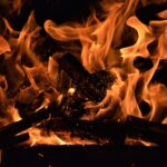 Close-up of roaring flames with glowing embers radiating heat and light. Perfect for warm and vivid backgrounds.