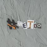 Text art 'MeToo' on concrete background highlighting social movement themes.