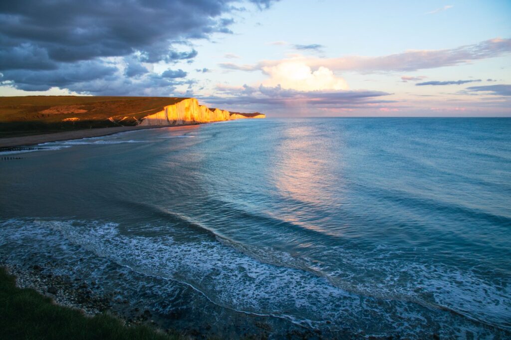 Stunning seascape of the white cliffs at sunset captured from the coast.