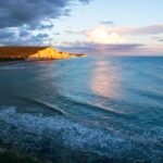 Stunning seascape of the white cliffs at sunset captured from the coast.