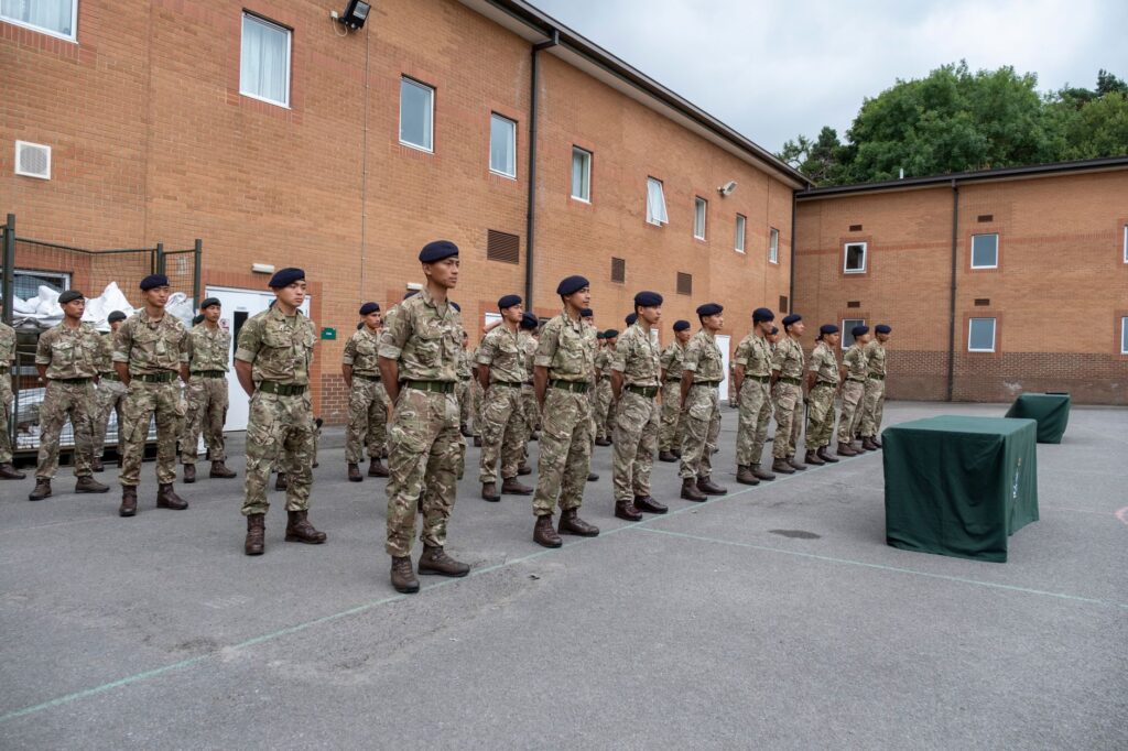 Soldiers in uniform standing in formation at Catterick Barracks, England.