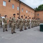 Soldiers in uniform standing in formation at Catterick Barracks, England.