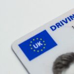 Detailed photo of a UK driving license showcasing EU flag and identity features.