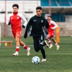 Young soccer players practicing during a training session on an outdoor field.