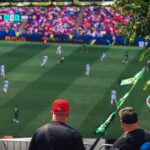 Engaging view of soccer fans enjoying a live match at a stadium in Langford, BC, Canada.