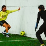 Two female soccer players in action during a match in Mexico City, demonstrating skill and teamwork.