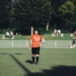 Back view of a football player wearing number 10 on a sunny day.