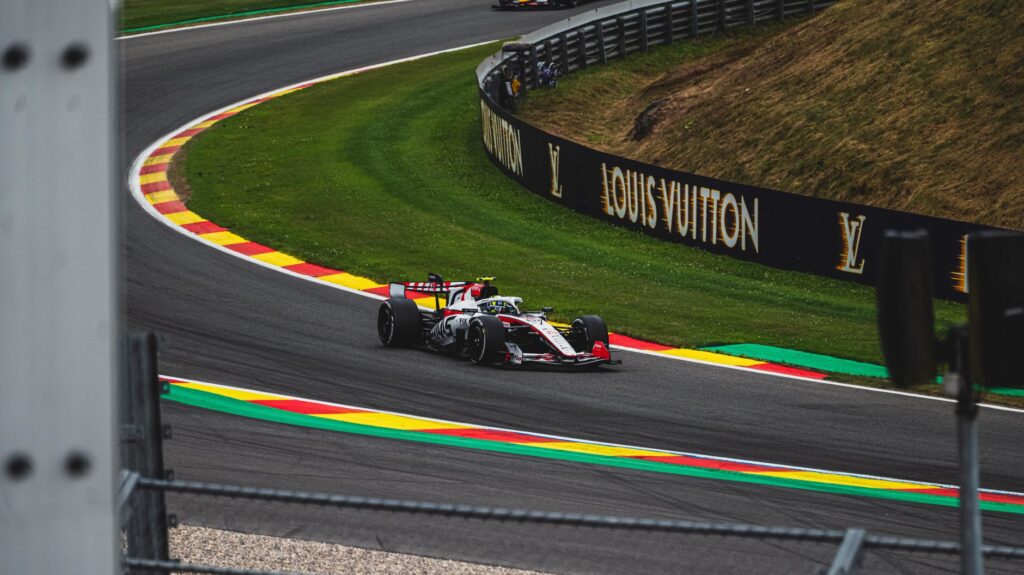High-speed Formula 1 car racing on famous Circuit de Spa-Francorchamps in Belgium.