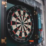 Round dartboard ready for game hanging on wall in cozy room at home
