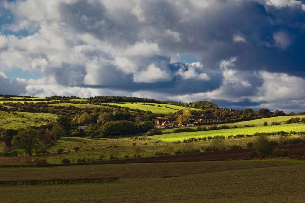 Beautiful rural landscape with rolling hills and fields under a dramatic sky in County Durham, UK.