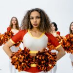 Group of cheerleaders showcasing team spirit with vibrant pom poms and uniforms.