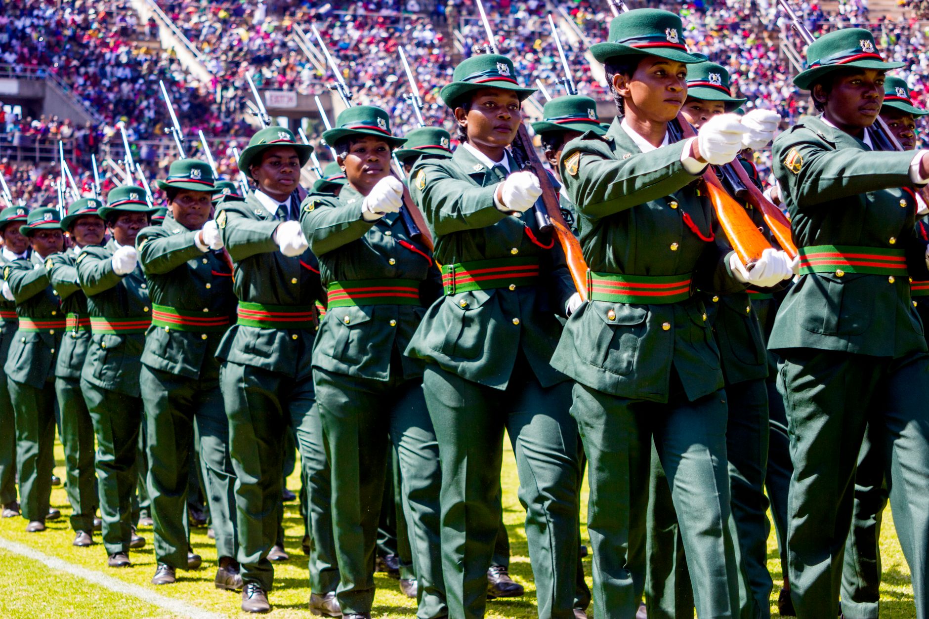 Uniformed women participating in a military parade at a stadium in Harare, Zimbabwe.