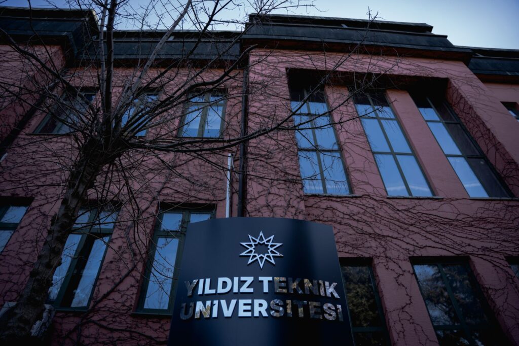 The facade of Yildiz Teknik University in İstanbul with visible signage and architectural details.