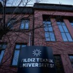 The facade of Yildiz Teknik University in İstanbul with visible signage and architectural details.