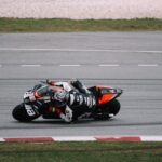Professional motorcyclist in action on Sepang track. Dynamic and thrilling motorsport moment.